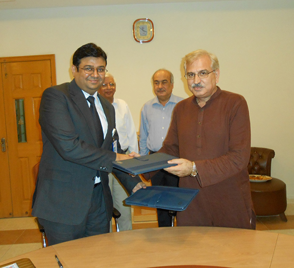 Mr. Ahmed Nauman Anees, Dy. Head of Learning and Development of Meezan Bank and Dr. Zafar Iqbal Jadoon, Dean, Business School, UCP exchanging the signed MoU